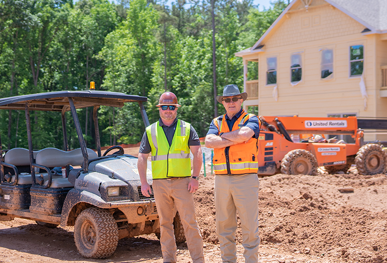 Construction site with two male workers in safety vests