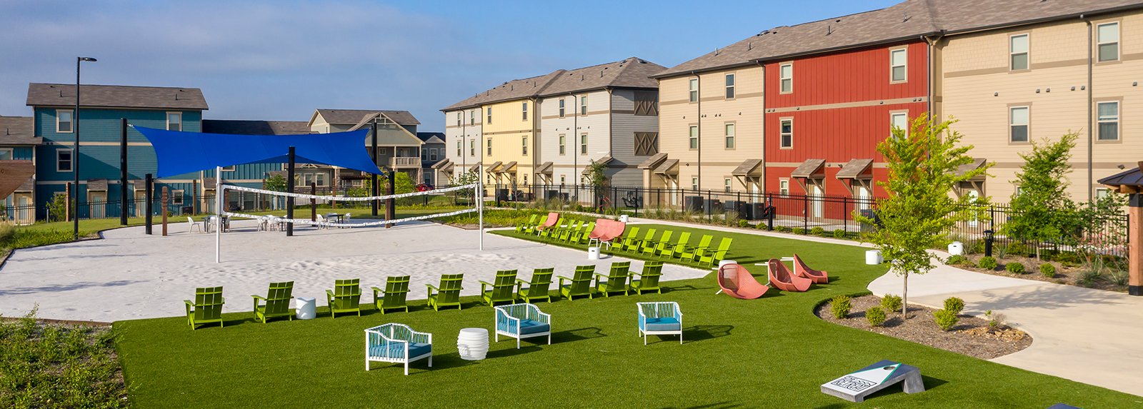 Sandy volleyball court surrounded by lounge seating