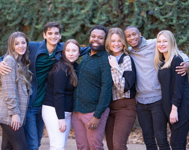 A group of friends together smiling